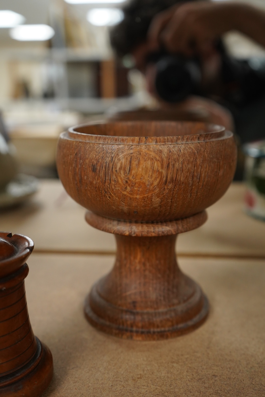 A 19th century treen tower tape measure and an oak goblet with provence label, 13cm